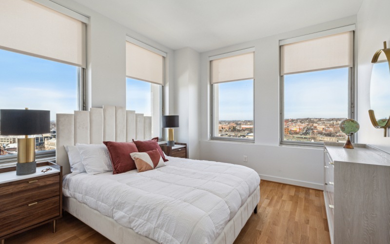bedroom with large windows and views of downtown Syracuse