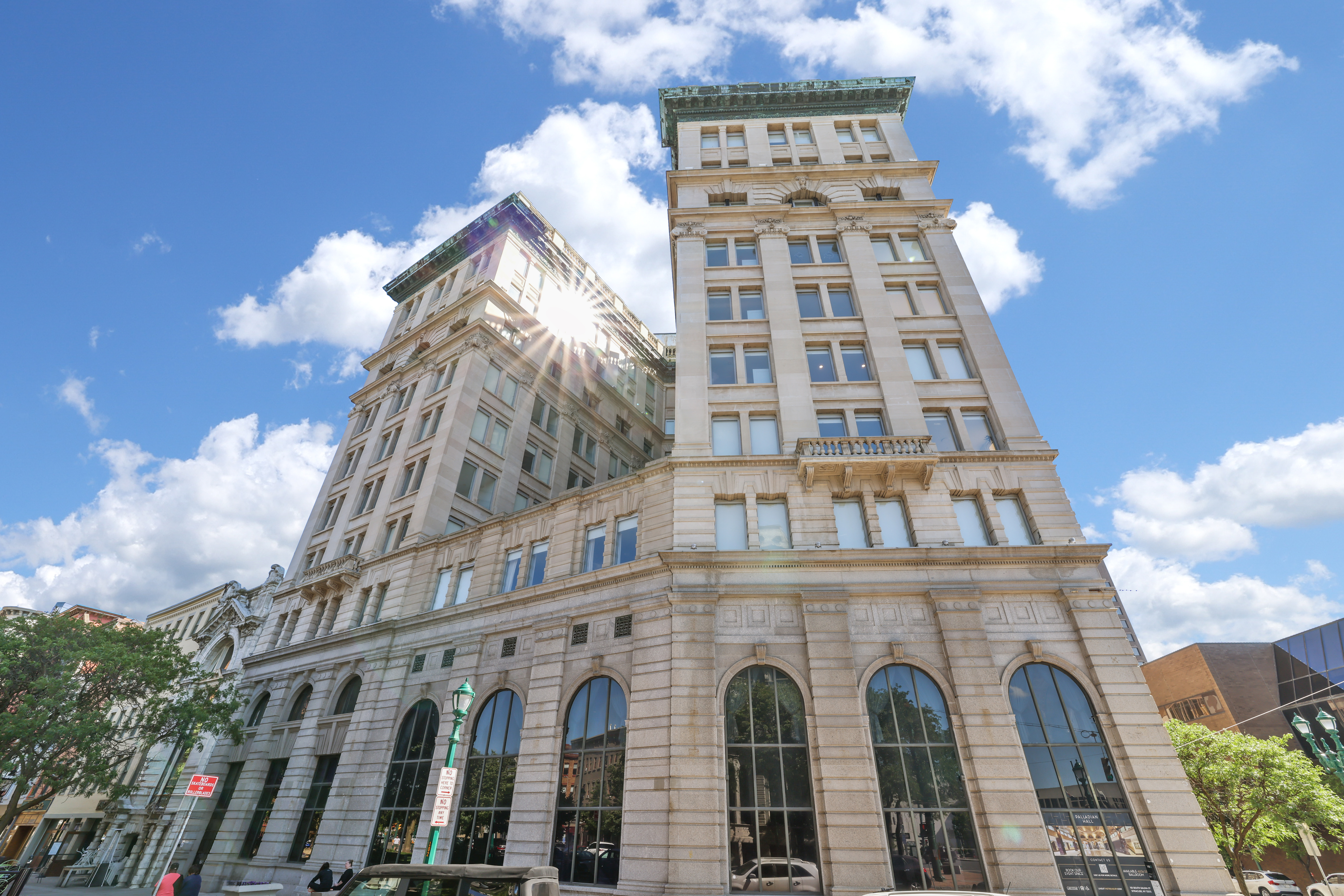 Panoramic exterior shot of The Treasury apartment building on a beautiful, blue-sky, sunny day